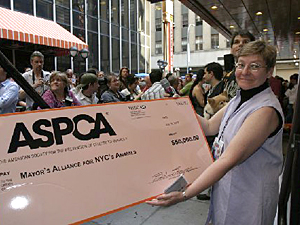 Mayor's Alliance President Jane Hoffman accepted a mock check representing a $50,000 donation to the Mayor's Alliance from Broadway Barks! sponsor and Alliance founding member, the ASPCA.