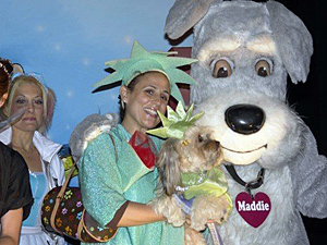 Beth Joy Knutsen and Bella Starlet Dog share the spotlight with the Maddie's Fund mascot on the animal float in the Village Halloween Parade. (Photo by Elizabeth Riley)