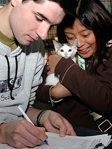 Many people, including this couple, adopted their new love at last year's Adopt-A-Cat. (Photo by Rick Edwards)