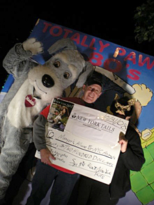 'New York Tails' publisher Diane West presented Steve Gruber. Director of Communications for the Mayor's Alliance, with a check at the annual Village Halloween Parade.
