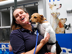 Elisabeth Manwiller, AC&C Volunteer Coordinator and Humane Educator, shows off a dog by the NSALA Mobile Unit at Adoptapalooza on May 22. All of the AC&C dogs brought to the event that day found new homes. (Photo by Dana Edelson)