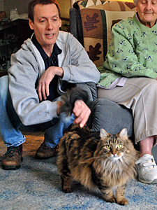 HSVMA award-winner and expert kitten socializer Mike Phillips visits with foster caretaker Janet Granger and one of her feline charges. (Photo by Gary Granger)