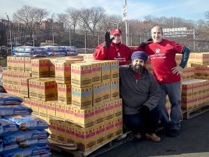 Alliance President, Jane Hoffman, and volunteers, Gurjinder Cheema and David Glicksman, get ready to move thousands of pounds of cat food into the vehicles of eager Certified TNR Caretakers at the most recent NYC Feral Cat Initiative giveaway on January 30, 2015. (Photo by Carol Zytnik)