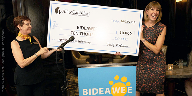Leslie Granger, President of Bideawee, accepted a pledge of $10,000 from Becky Robinson, President of Alley Cat Allies, to kick off Bideawee's matching grant fundraising campaign for the New York City Feral Cat Initiative at a gathering of supporters at the Algonquin Hotel on October 3, 2019. (Photo by Mark McQueen, phoDOGraphy.com)