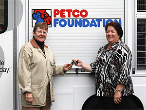 The Petco Foundation's Susan Rosenberg, National Grants and Disaster Relief Manager, presents Mayor's Alliance President Jane Hoffman with the keys to the brand new pet adoption van. (Photo by Jenna Leigh Teti)