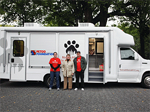 Mayor's Alliance staff members Siobhan Healy and Steve Gruber join President Jane Hoffman by the new adoption van at the Petco National Adoption Reunion in Central Park. (Photo by Jenna Leigh Teti)